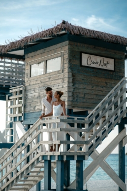 Couple standing on the stairs of the Crow’s Nest at Villa Nautica, overlooking the lagoon