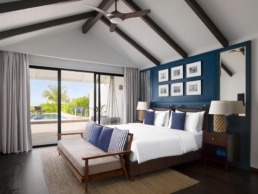 Bedroom of a Deluxe Beach Pool Villa at Villa Nautica Maldives with king bed and terrace opening to the beach