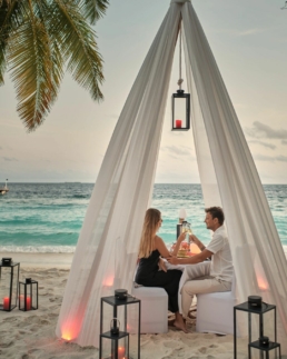 Couple enjoying a candlelit private dining experience at Royal Island