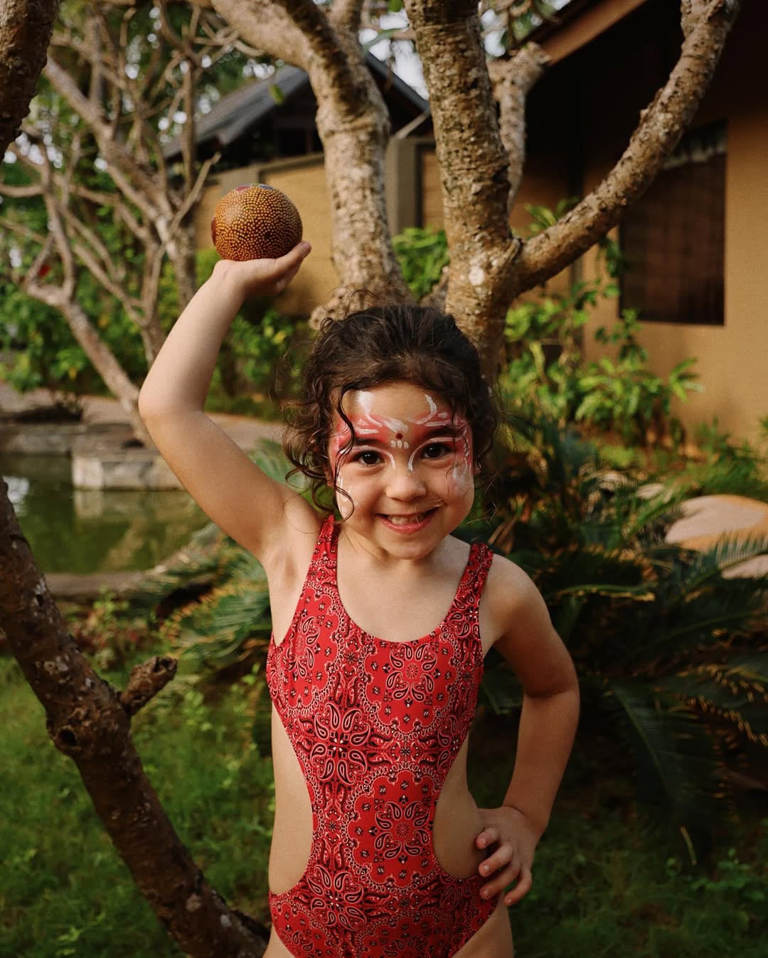 Child smiling in the gardens near Araamu Spa, Villa Park