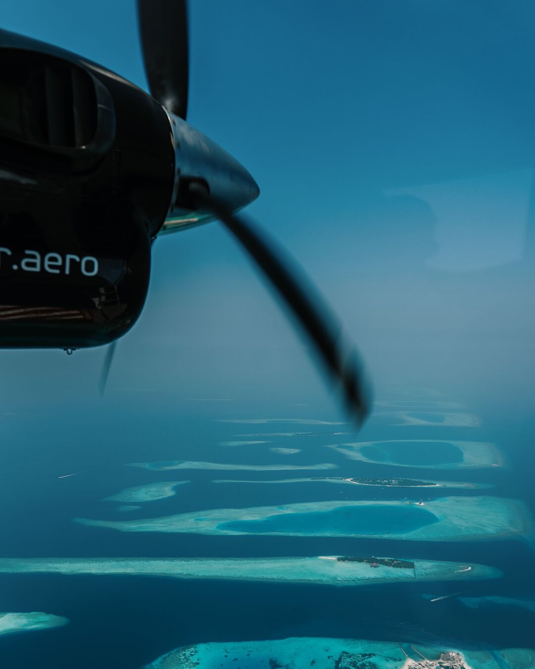 Clear blue Maldivian sky seen during a Villa Air Maldives seaplane journey to Villa Park